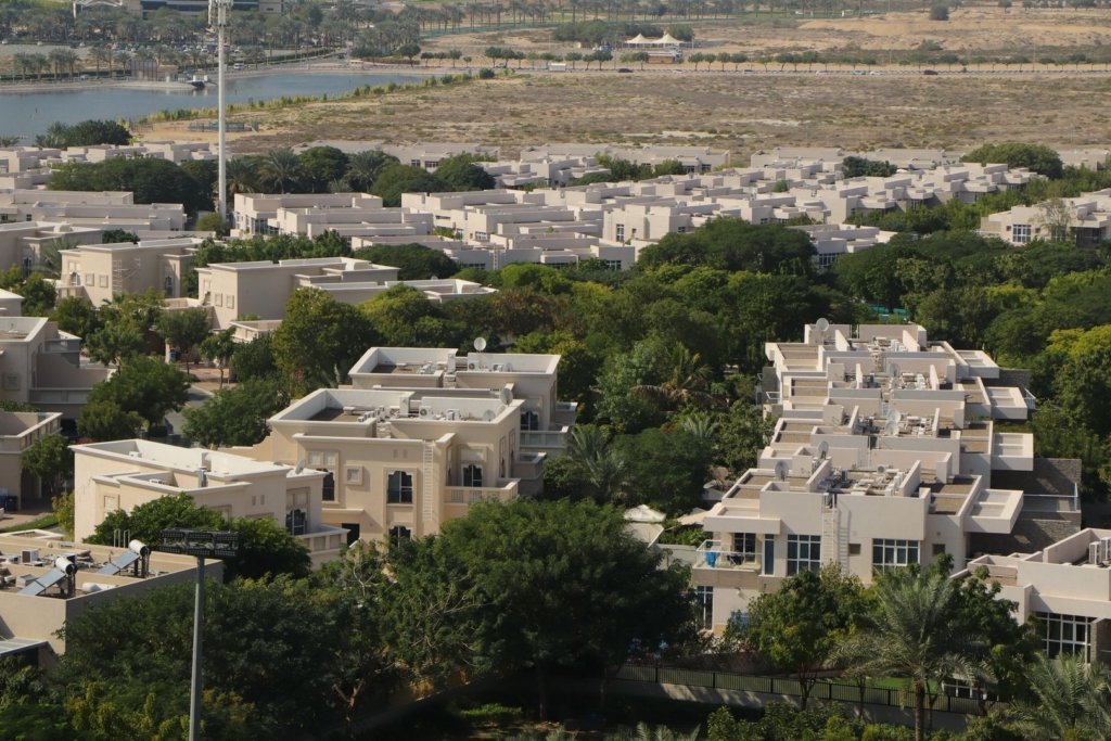 Aerial view of Nad Al Sheba villa community in Dubai with lake and green landscaping