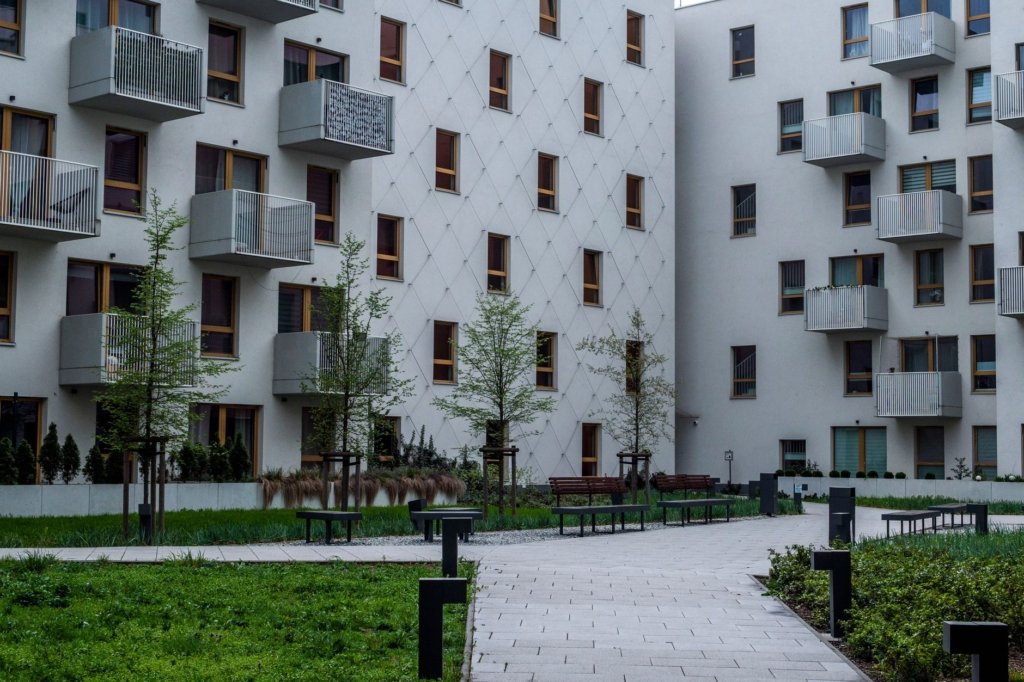 Modern mid-rise apartment buildings with balconies and landscaped courtyard in Arjan, Dubai