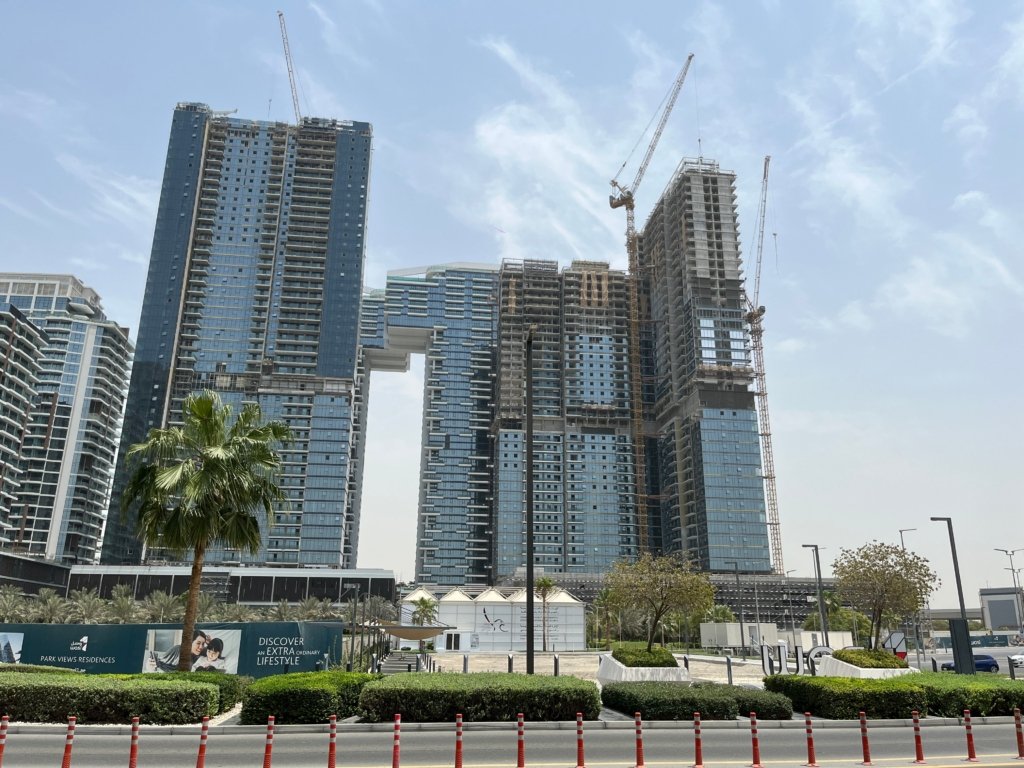 Aerial view of skyscraper construction with cranes in Dubai, reflecting the scale of development driving Dubai South growth