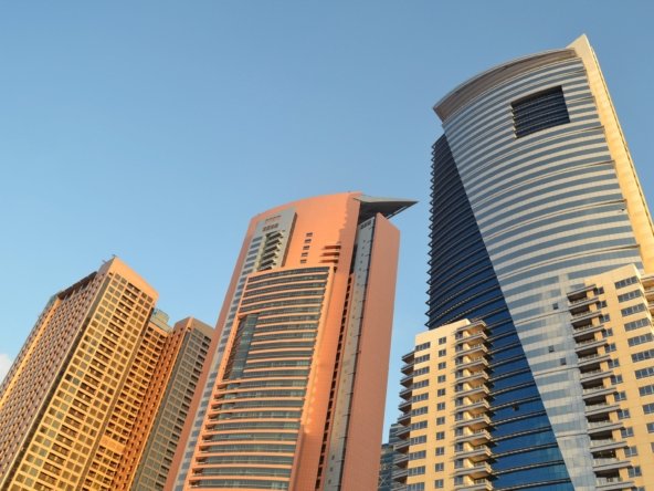 Dubai high-rise residential towers at golden hour, illustrating property investment for UAE Golden Visa eligibility