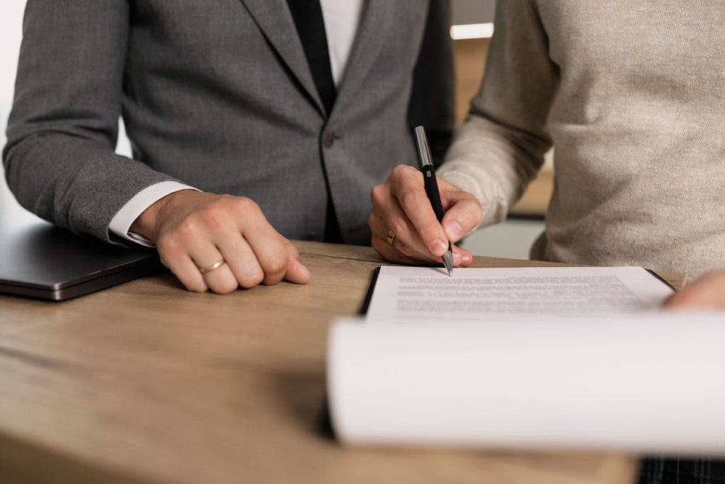 Investors signing a property purchase contract, relevant to Dubai off-plan payment plan agreements