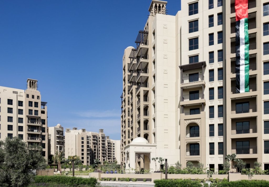 Modern Dubai residential apartment towers in a landscaped community, illustrating rent vs buy property decisions in Dubai