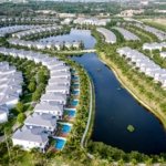 Aerial view of Tilal Al Ghaf lagoon-side villa community with private pools and crystal lagoon