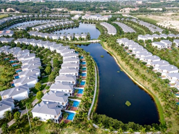 Aerial view of Tilal Al Ghaf lagoon-side villa community with private pools and crystal lagoon