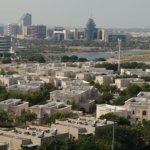 Aerial view of an established Dubai residential villa community with palm-lined streets, representing affordable freehold areas under AED 2 million