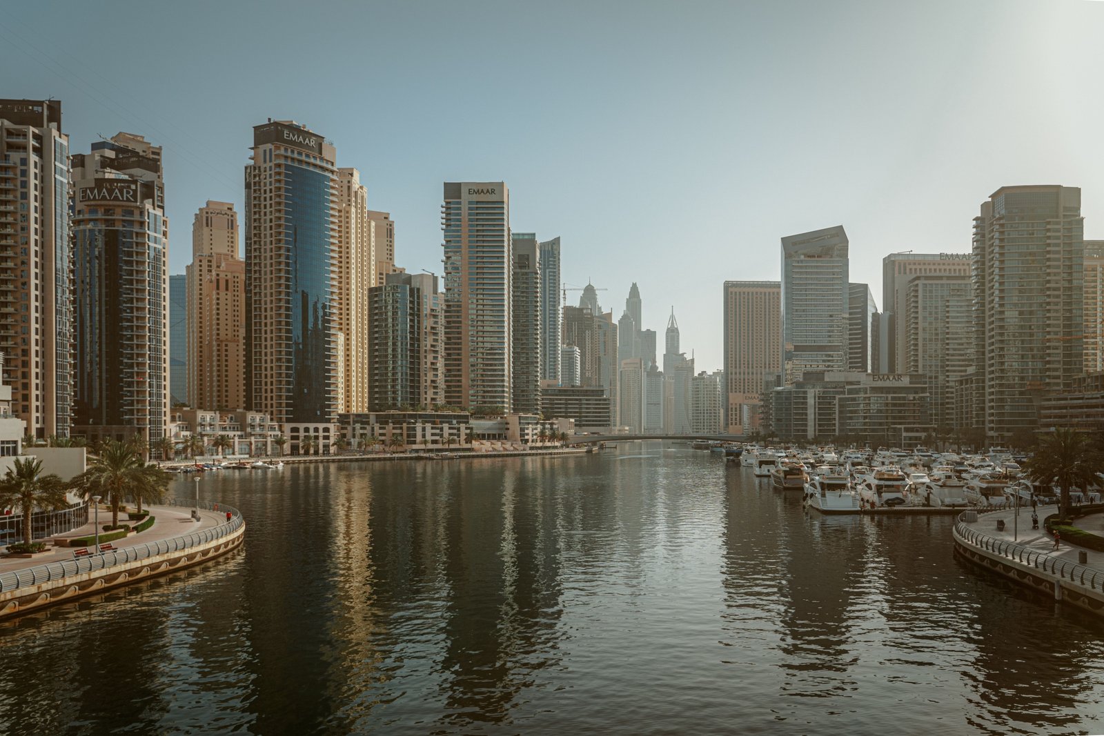 Dubai Marina waterfront skyline with high-rise towers, promenade and yachts moored along the marina