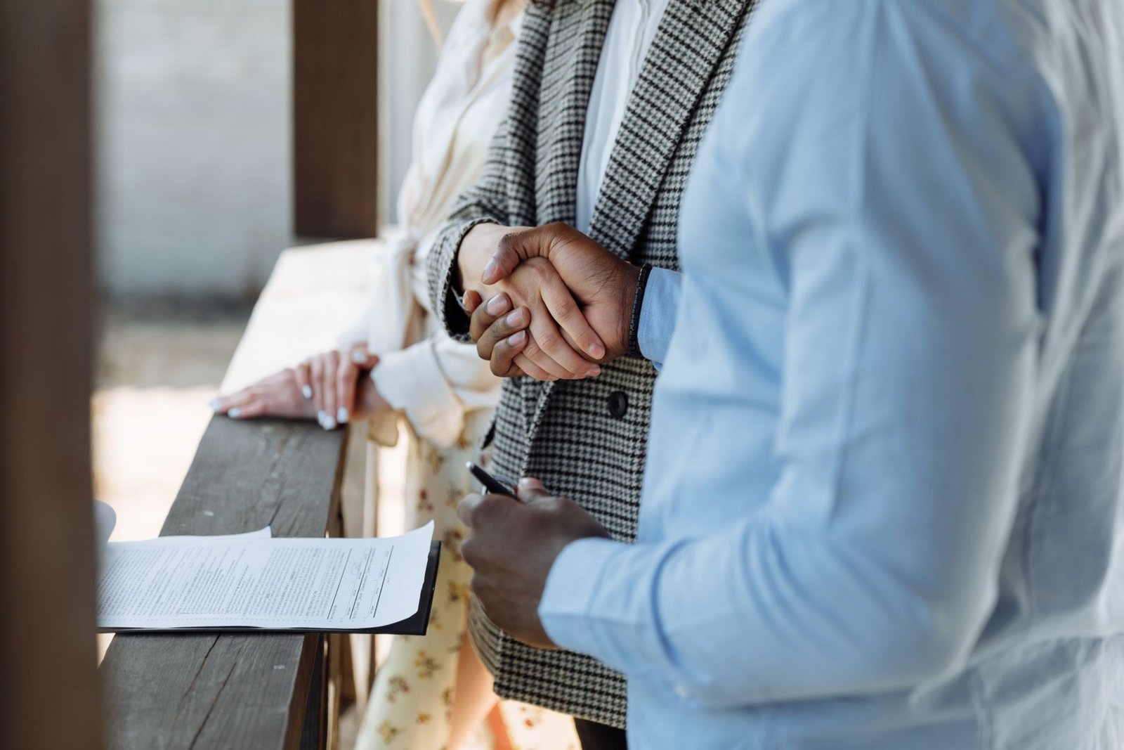 A buyer and seller reviewing paperwork before signing an off-plan property assignment sale agreement in Dubai