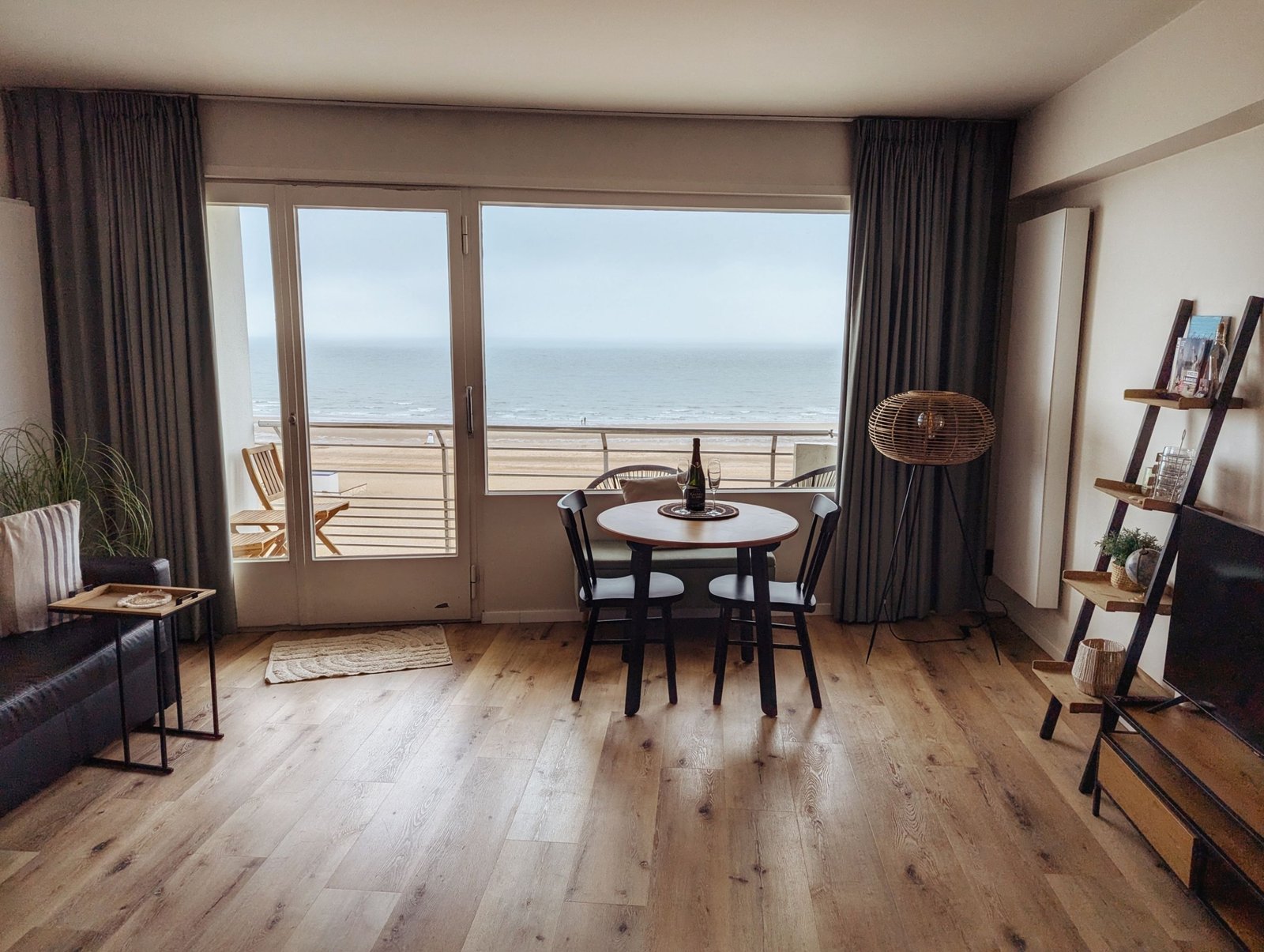 Beachfront holiday home living area with dining table and ocean view, representing a licensed Dubai short-term rental