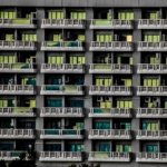 Facade of an apartment building with rows of balconies and windows, illustrating residential units that may qualify for a 2-year property investor visa