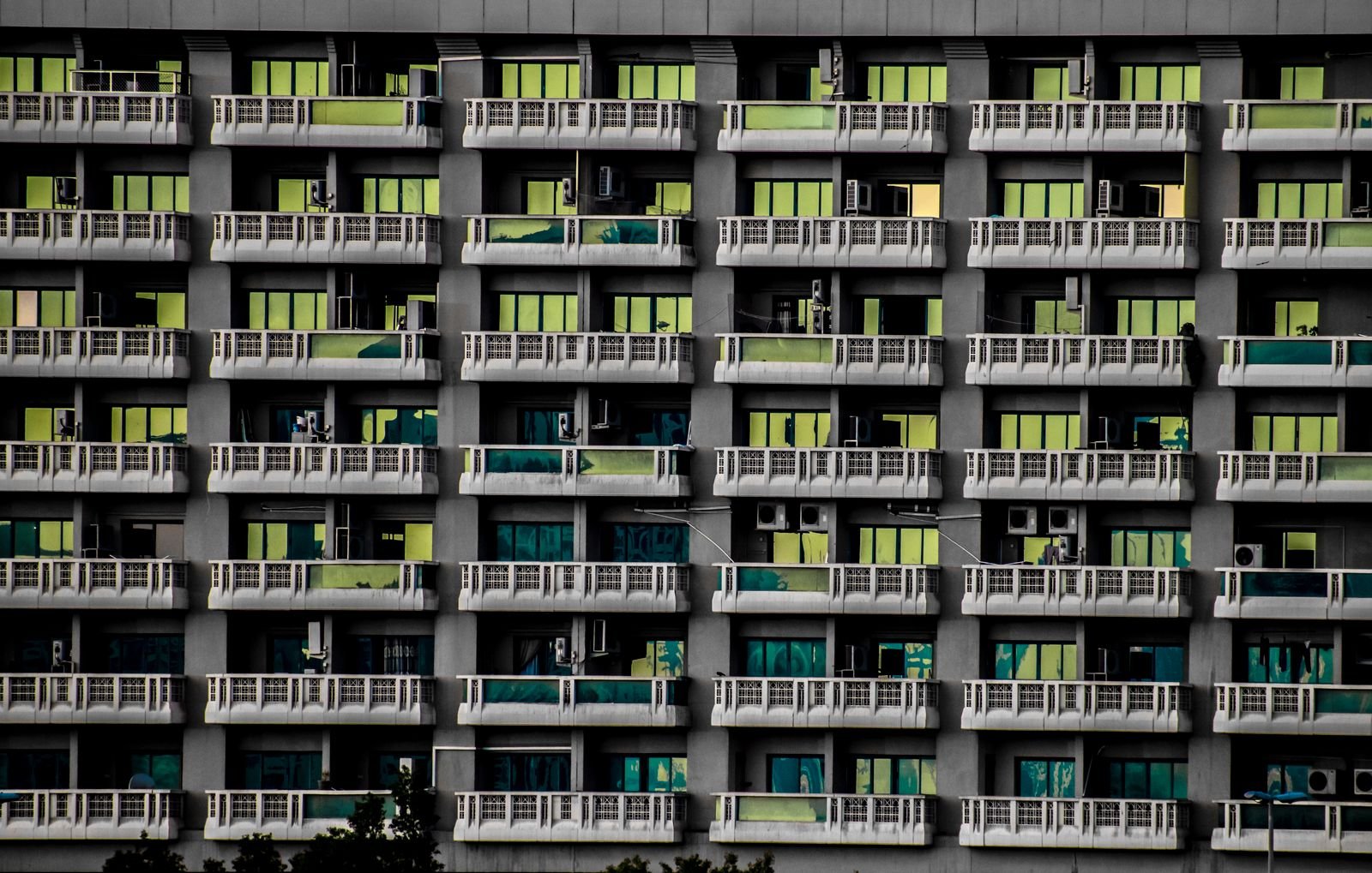 Facade of an apartment building with rows of balconies and windows, illustrating residential units that may qualify for a 2-year property investor visa
